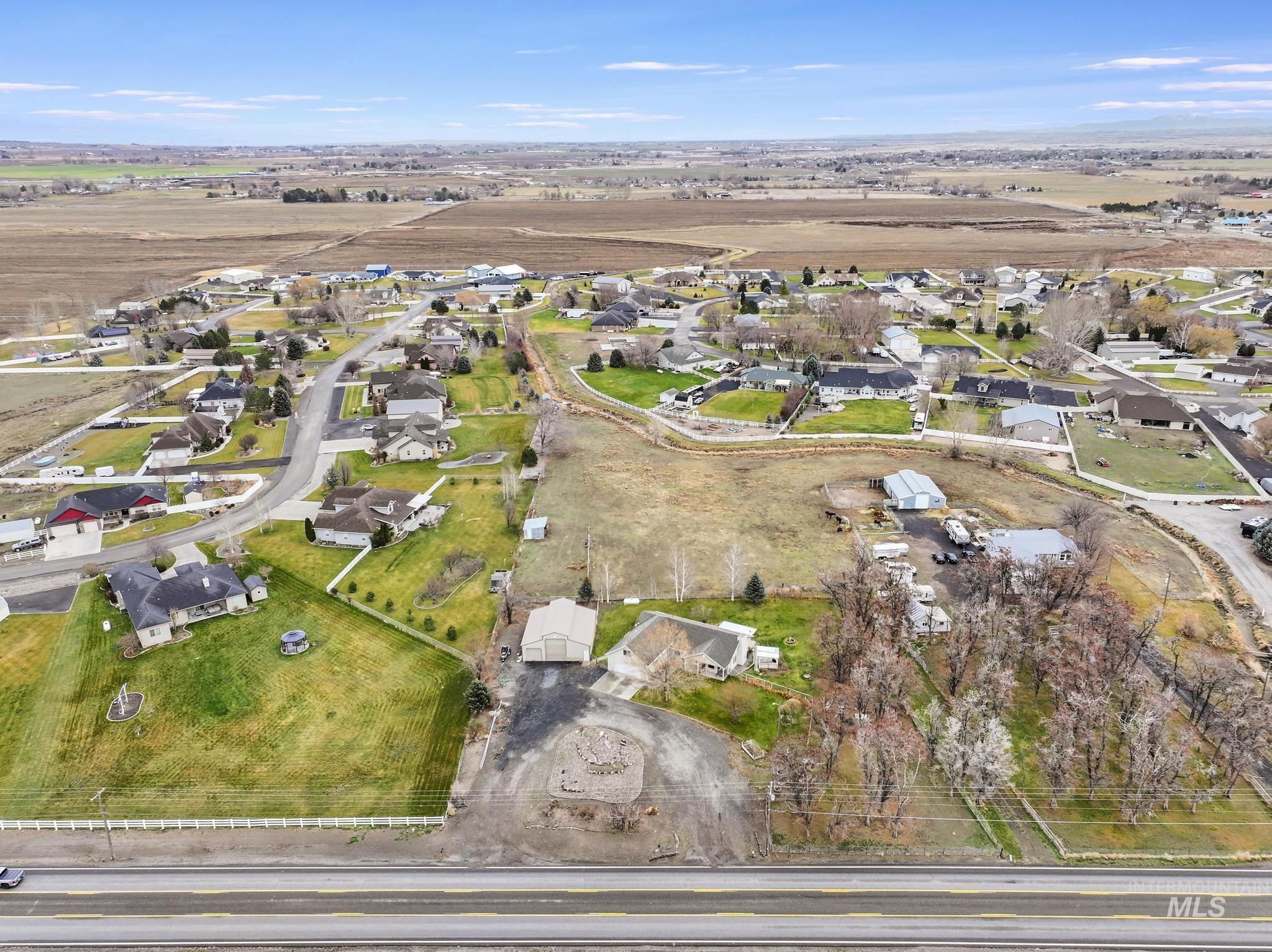Aerial overview of property's location featuring nearby suburban area and rural landscape