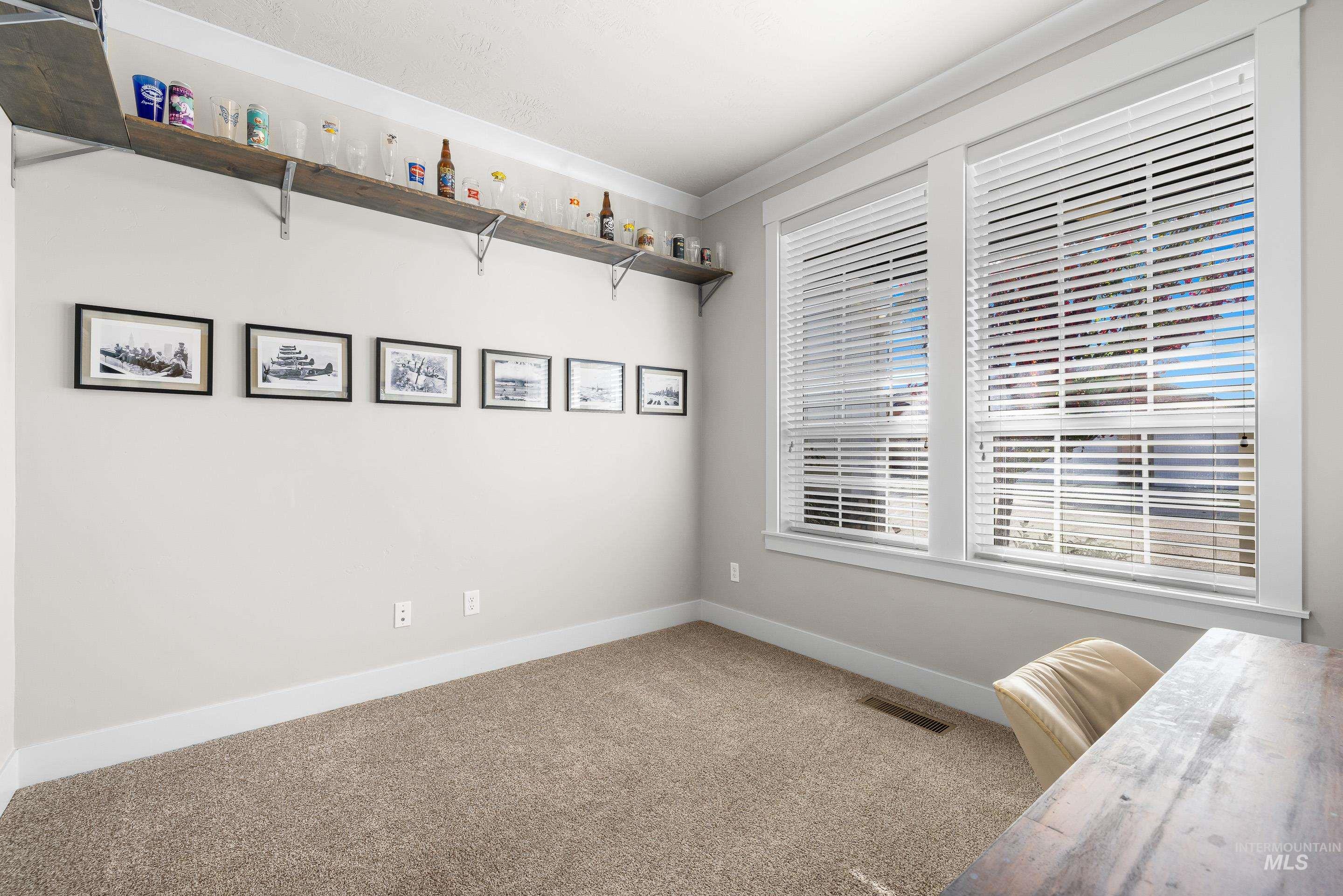 Unfurnished office with carpet and baseboards