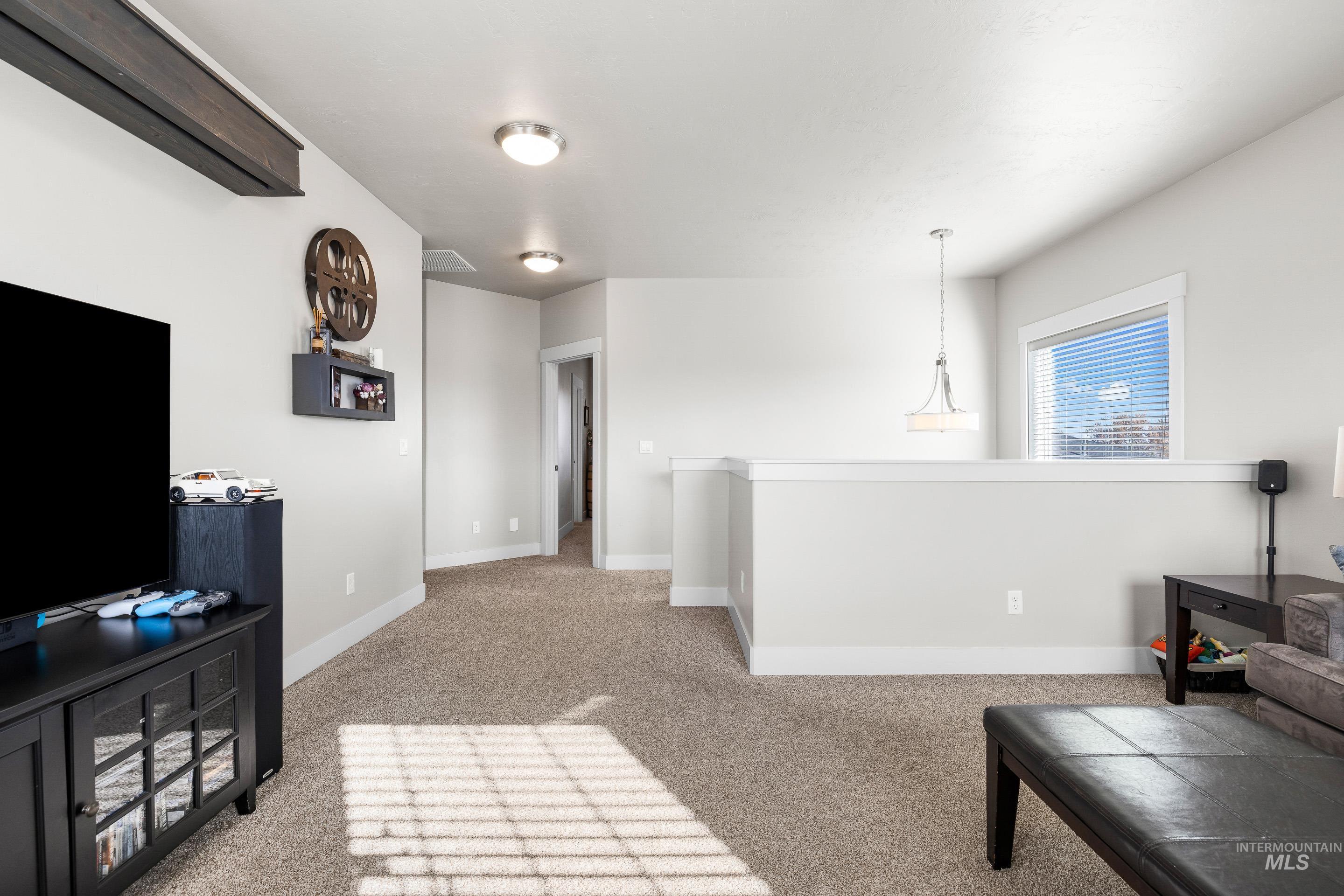 Living room featuring light carpet and baseboards