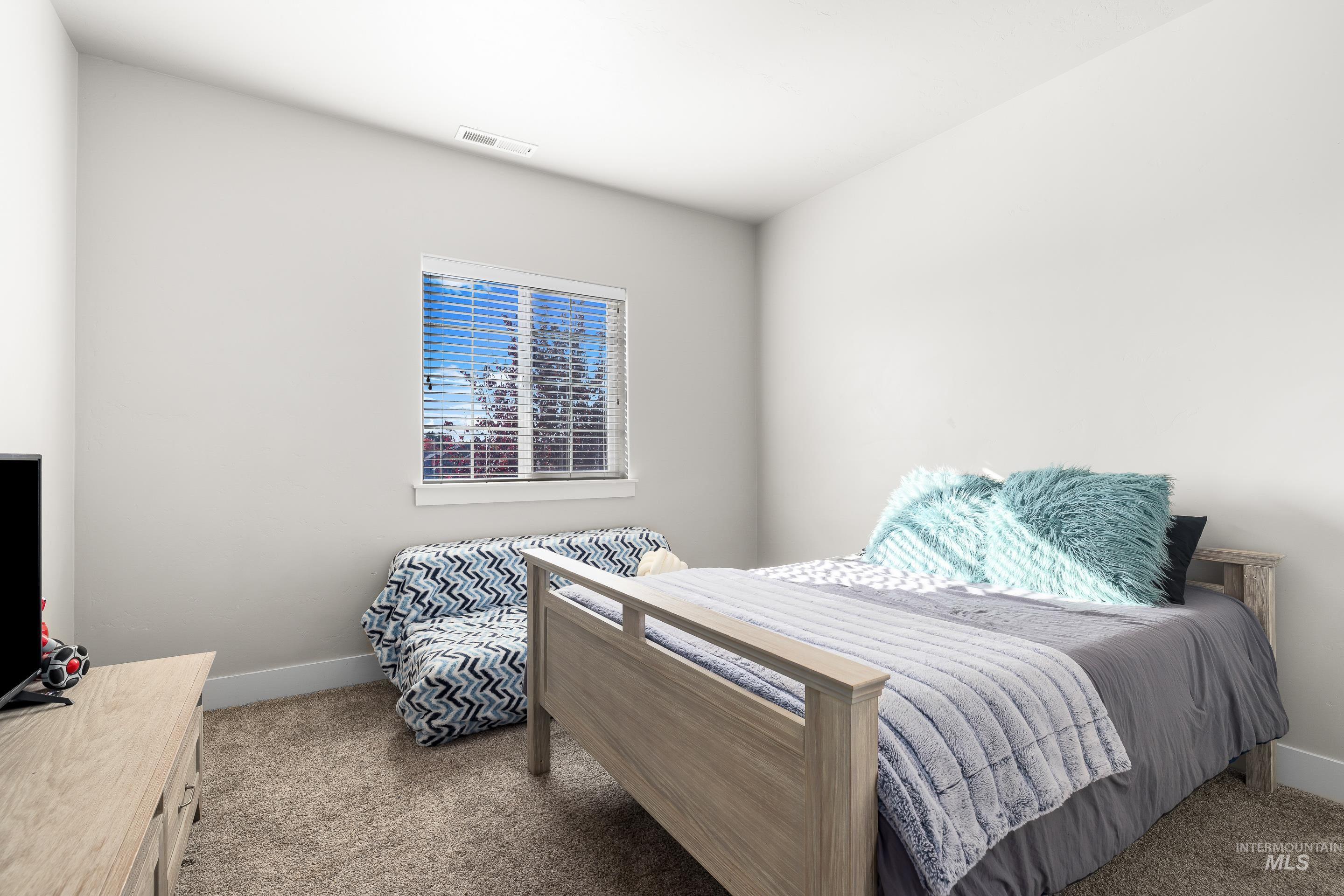 Bedroom with carpet floors and baseboards