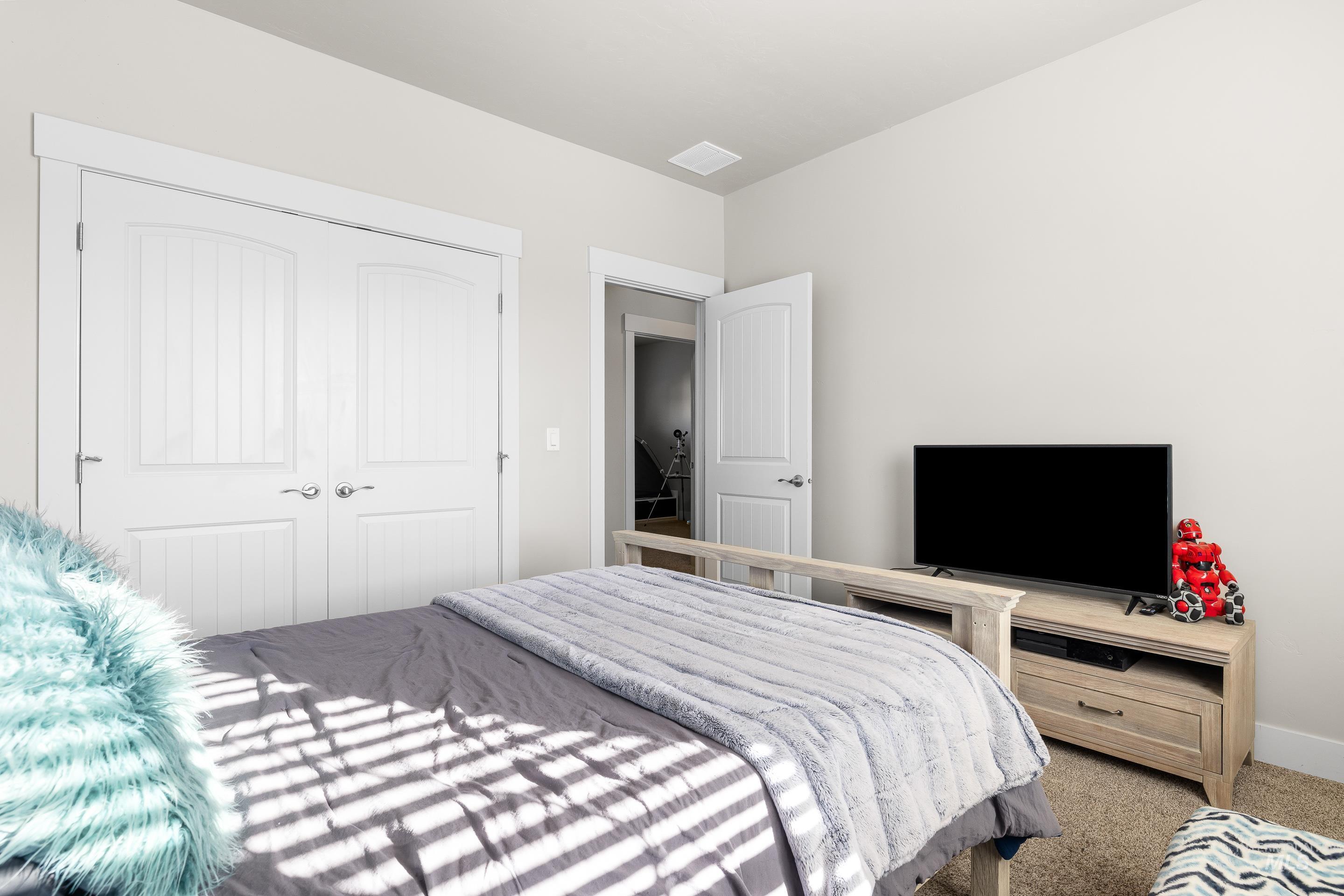 Bedroom featuring carpet flooring and a closet