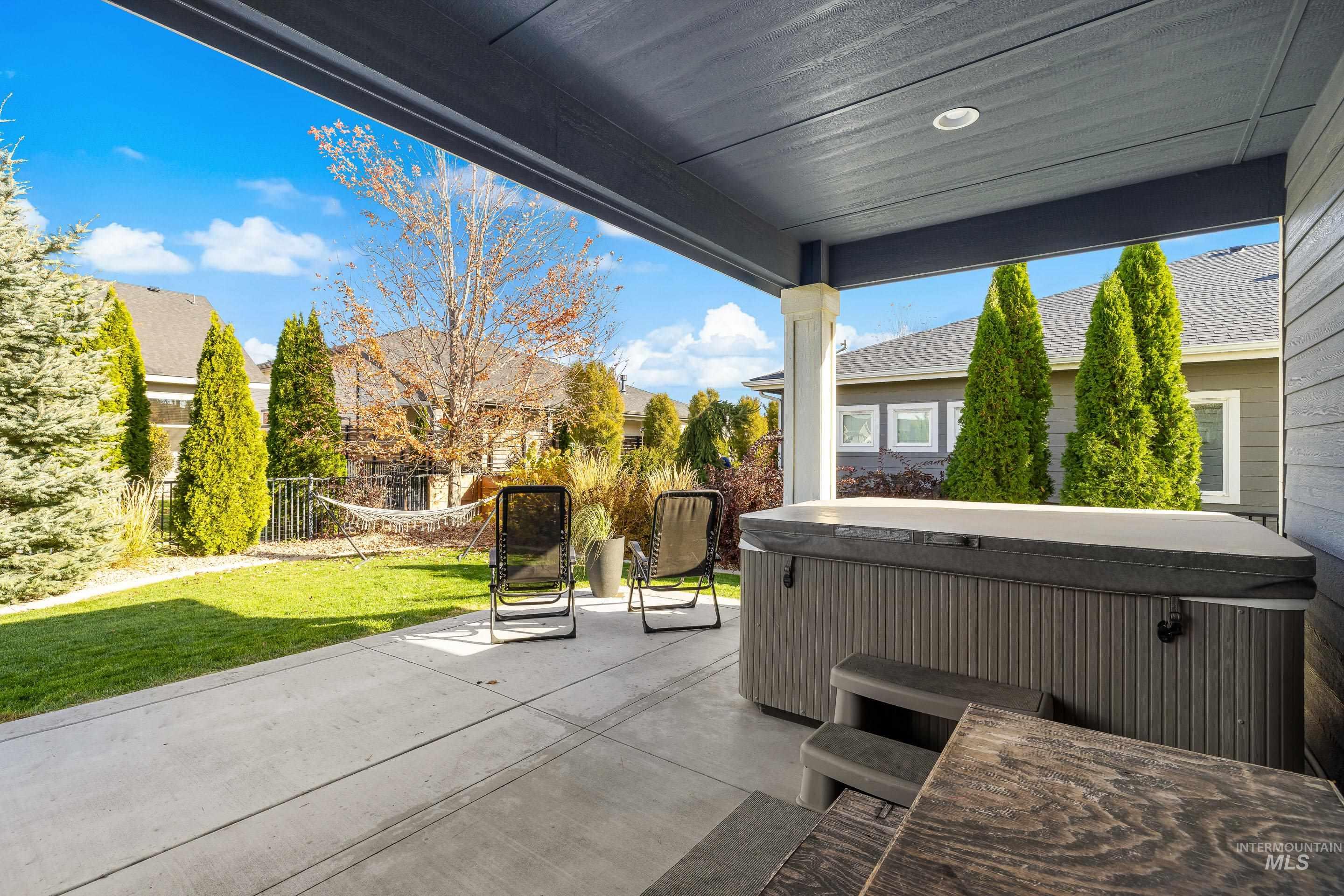View of patio with a hot tub