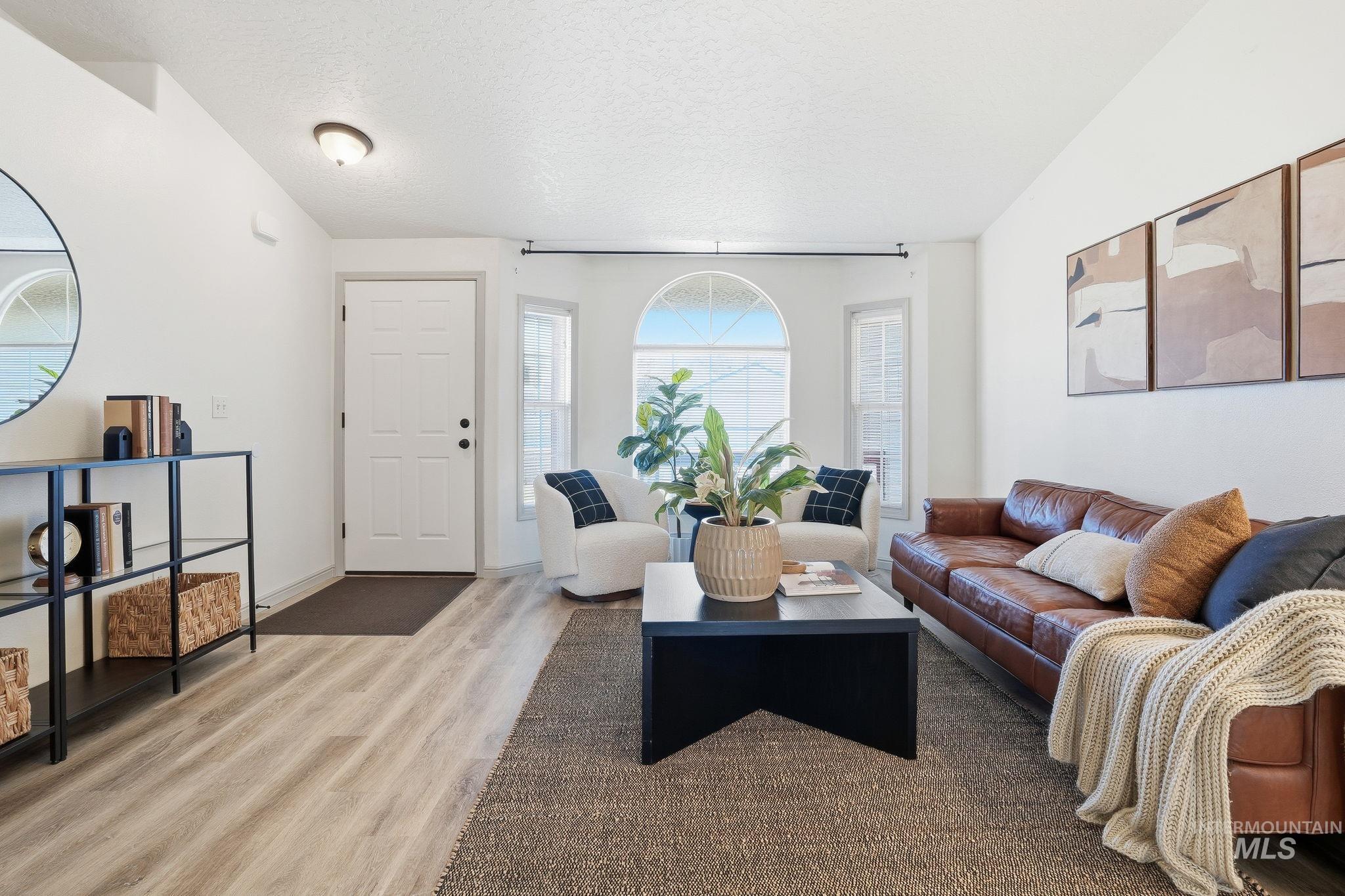 Living area featuring a textured ceiling and wood finished floors