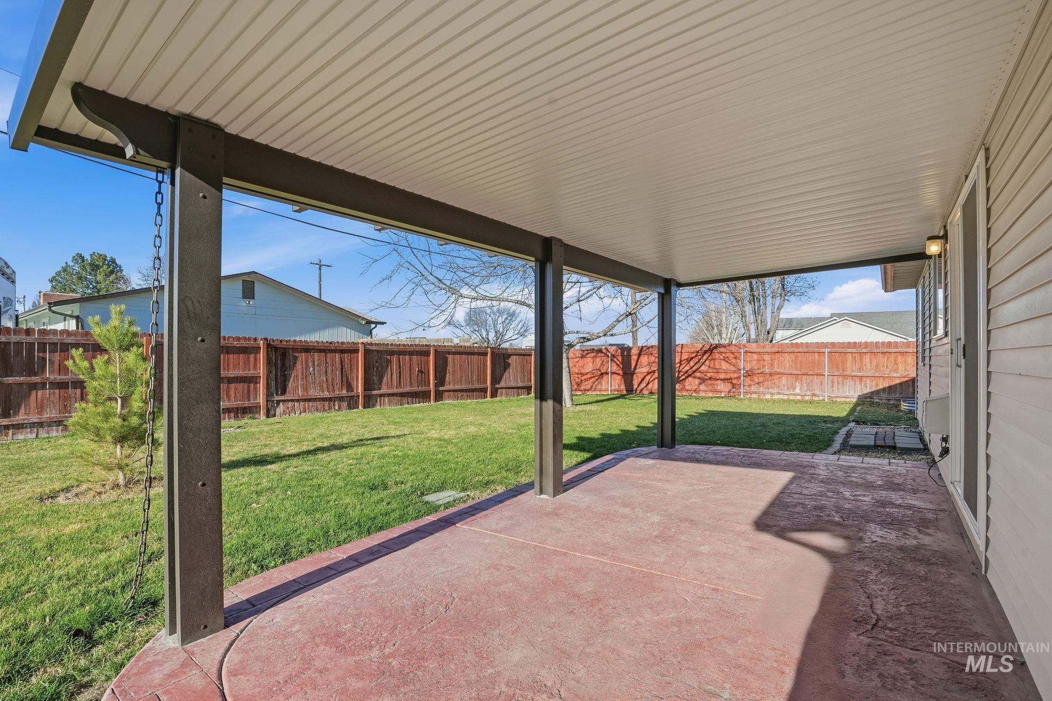 Fenced backyard with a patio area
