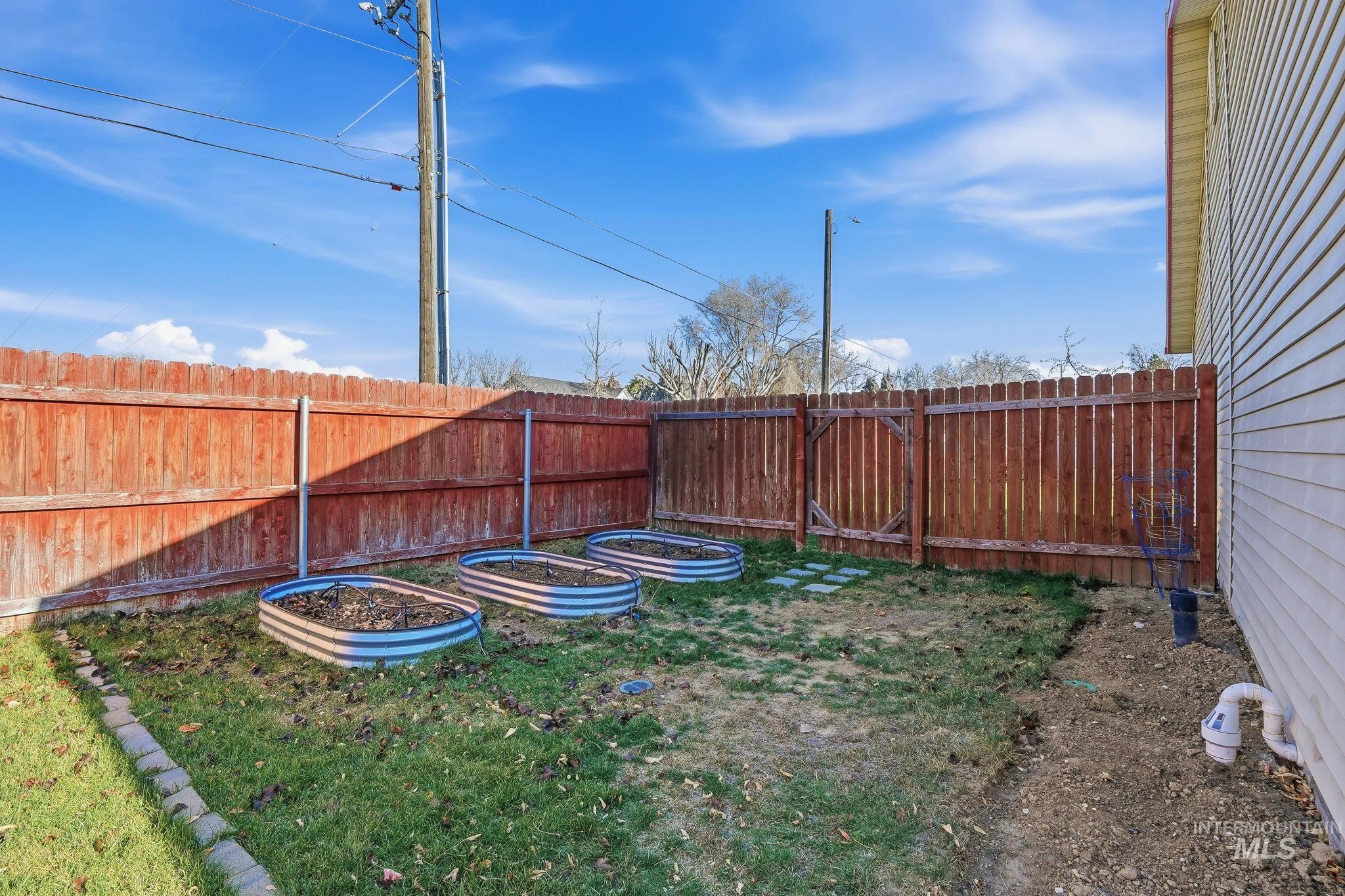 Fenced backyard with a garden