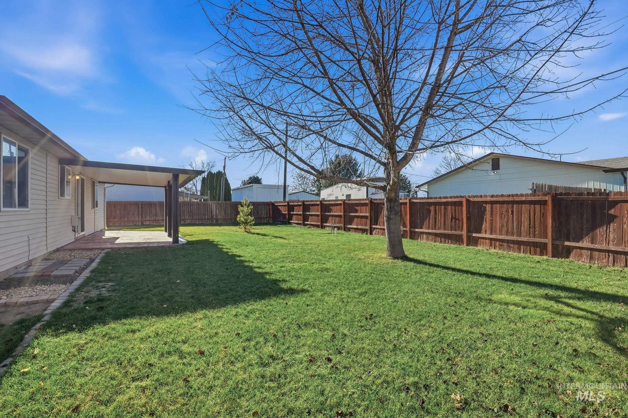 Fenced backyard with a patio area