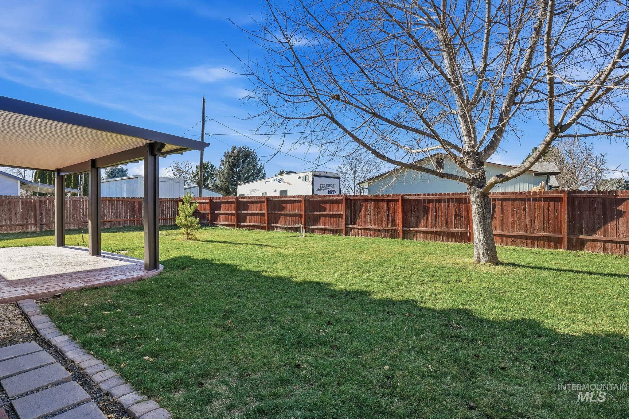 Fenced backyard featuring a patio
