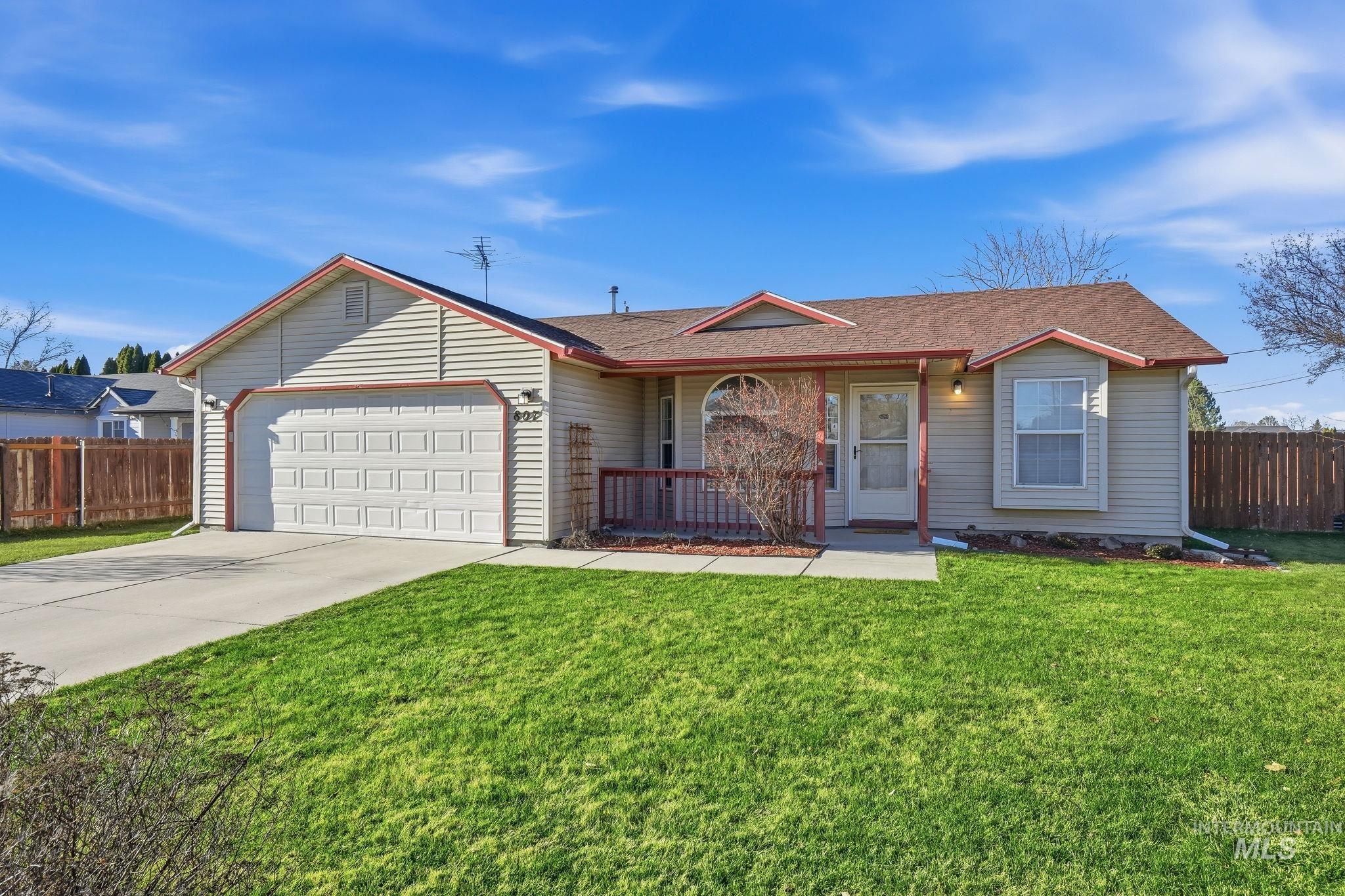 Ranch-style home with concrete driveway, a shingled roof, a garage, and a porch