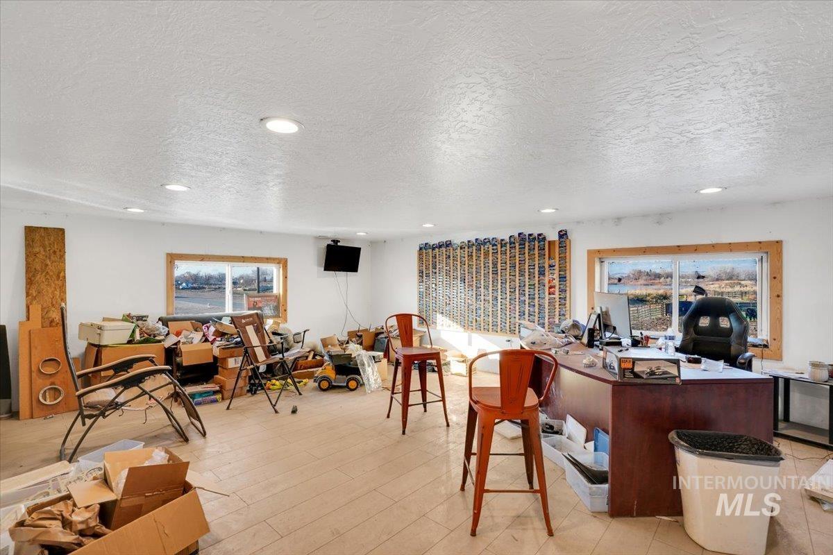 Office area with a textured ceiling and recessed lighting