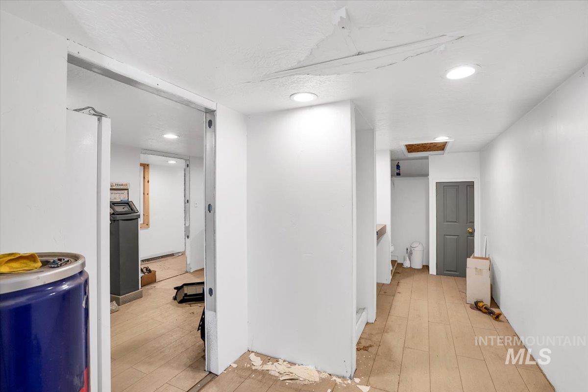 Corridor featuring light wood-style flooring and recessed lighting