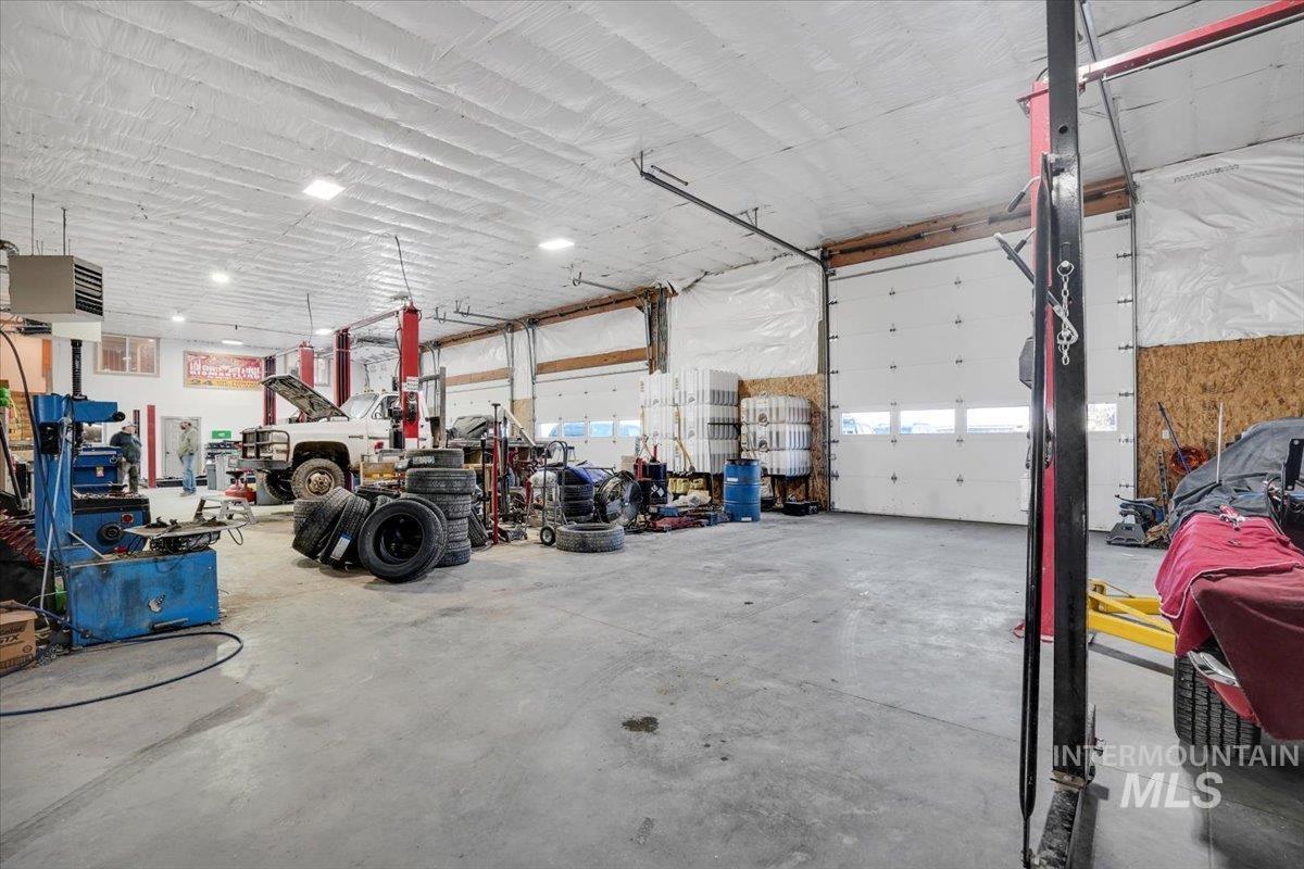 Garage featuring a heating unit and a workshop area