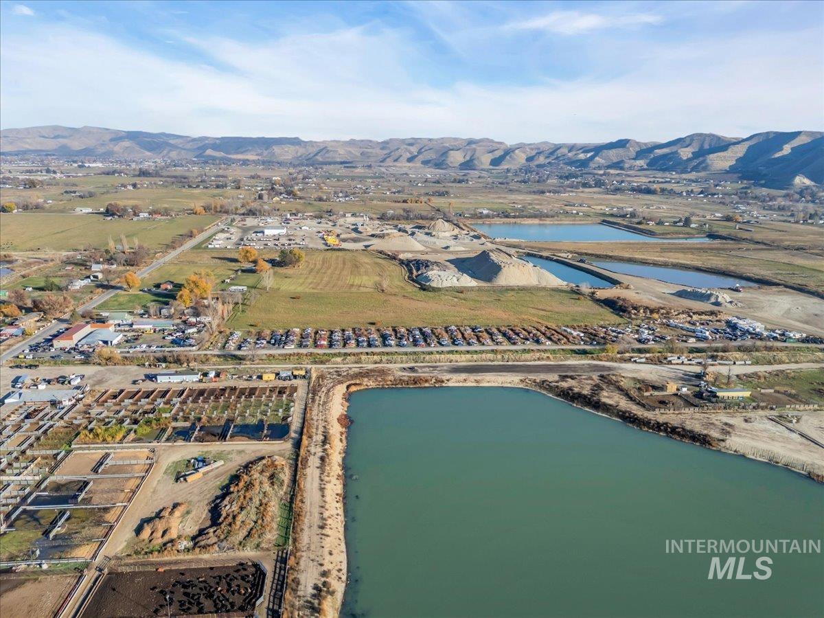 Aerial view of property's location featuring a water and mountain view and rural landscape