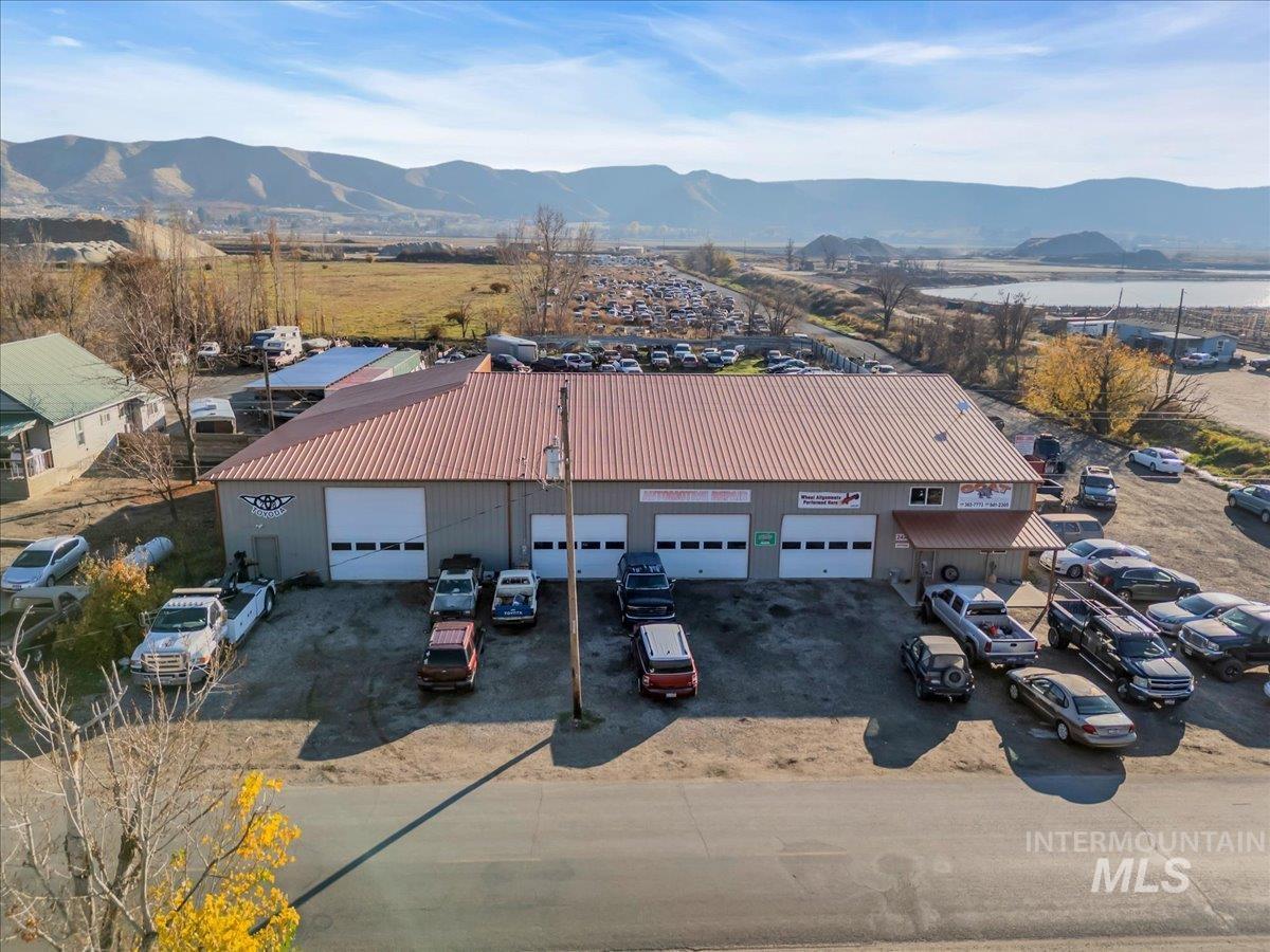 Aerial view of a mountain backdrop and an industrial area