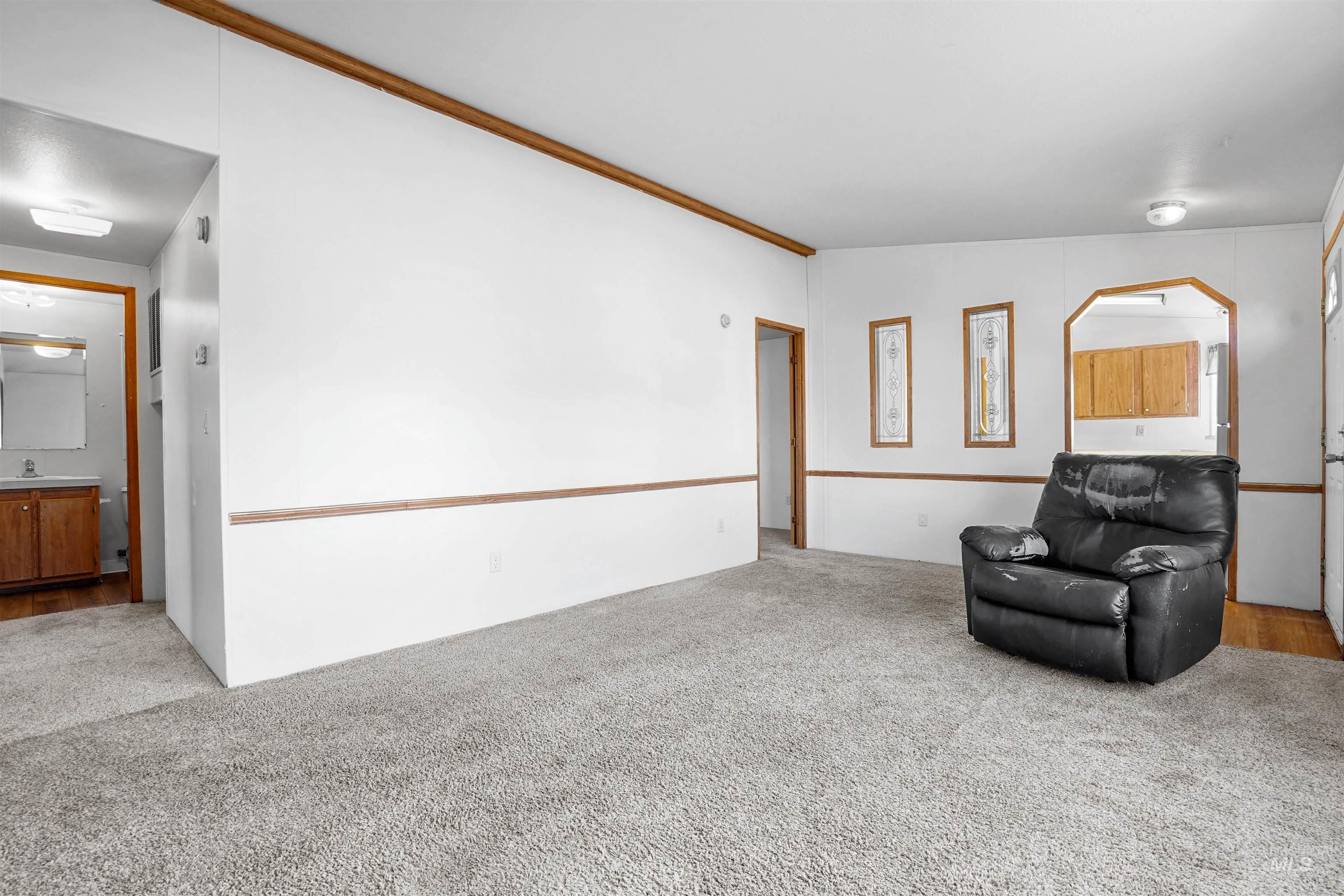 Sitting room with carpet floors and crown molding