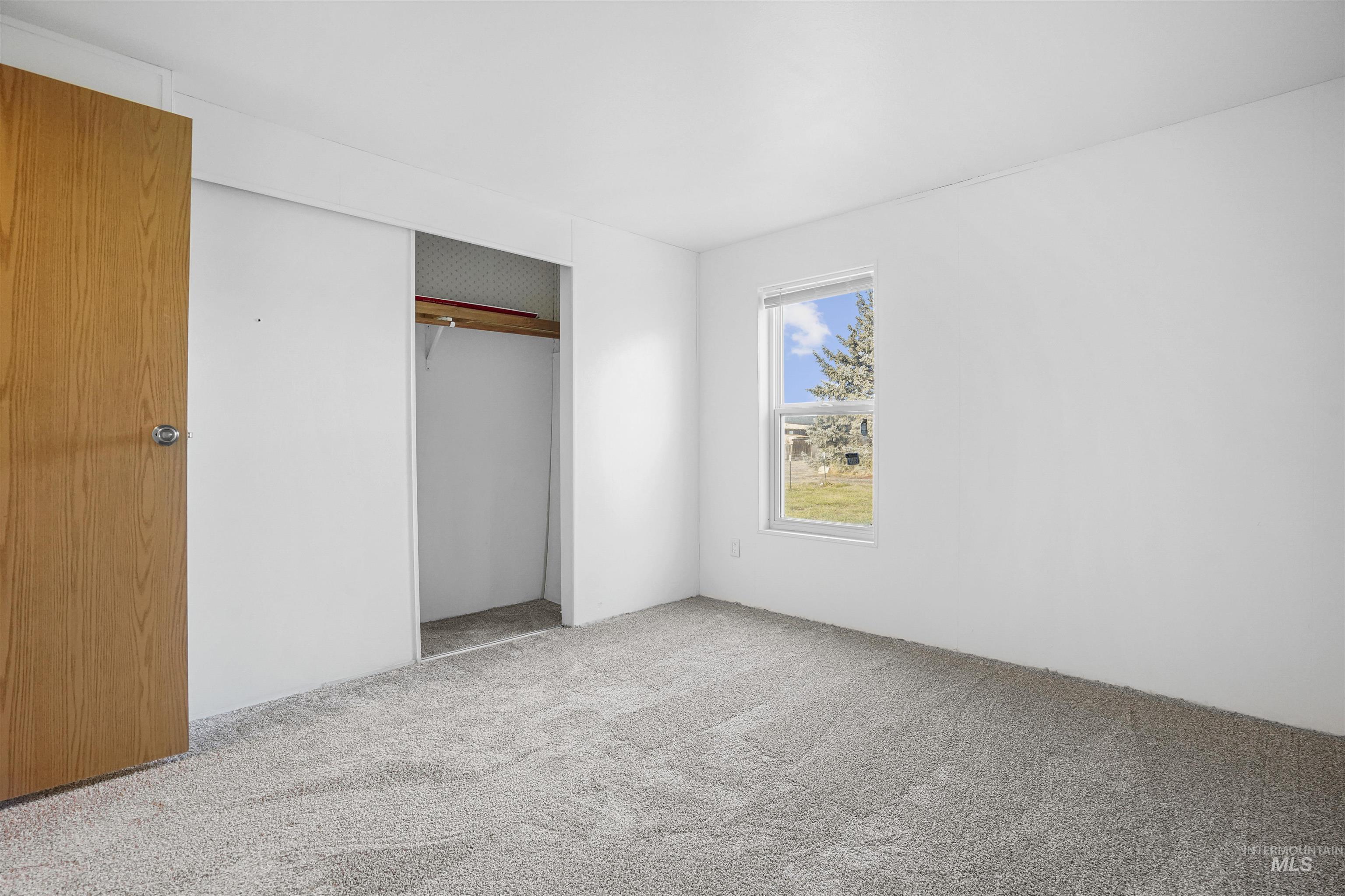 Unfurnished bedroom featuring carpet and a closet