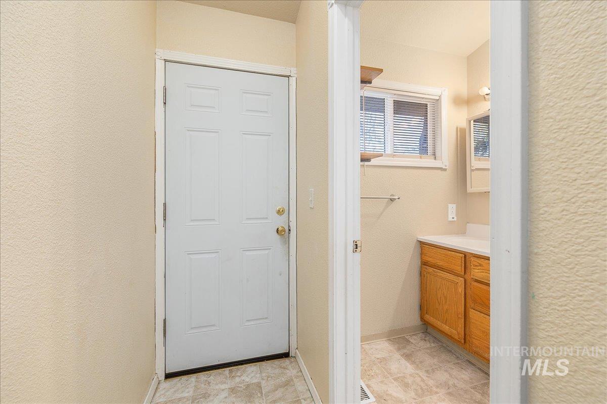 Bathroom with vanity and a textured wall