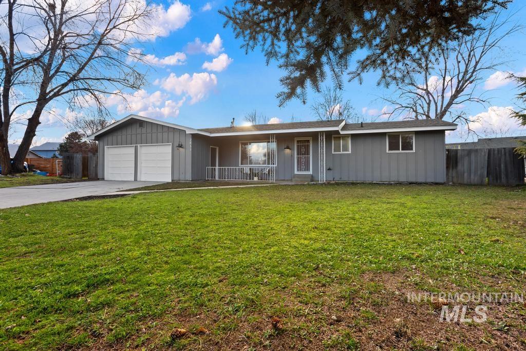 Ranch-style house featuring a porch, concrete driveway, board and batten siding, and a garage