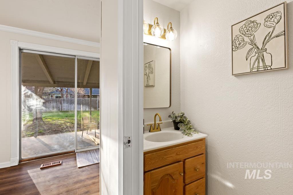 Bathroom with vanity and dark wood-type flooring