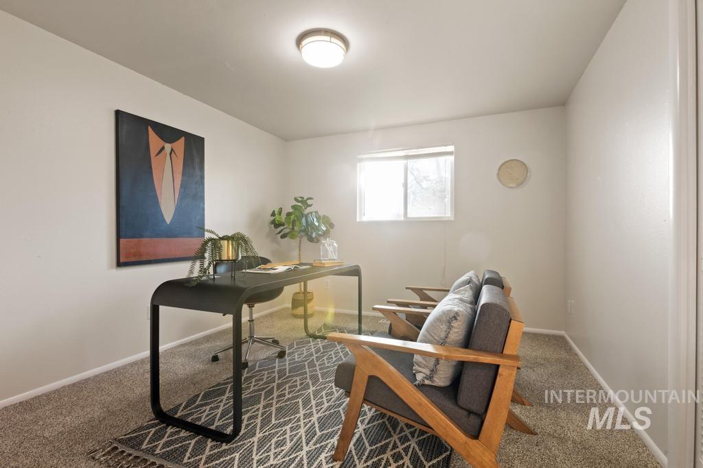 Carpeted home office with baseboards