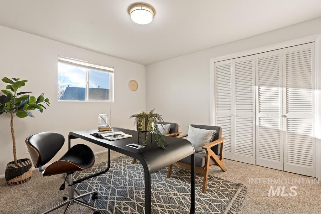 Home office featuring light carpet