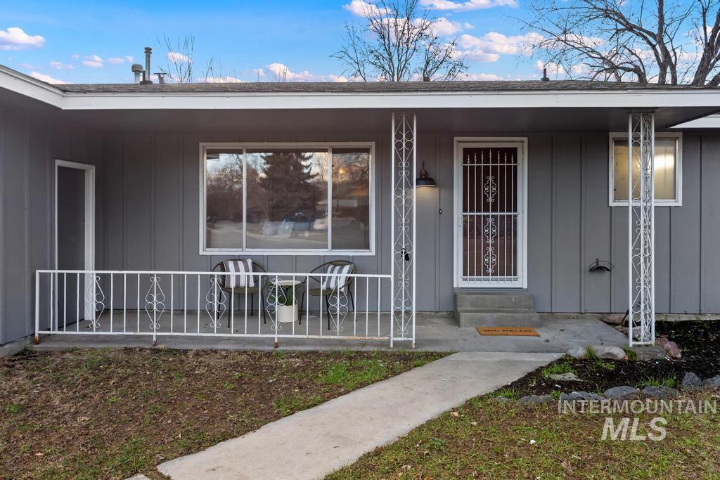 Doorway to property featuring board and batten siding and a porch