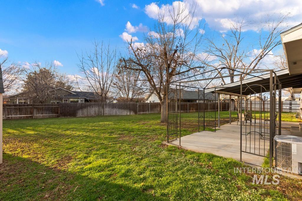 Fenced backyard with a patio