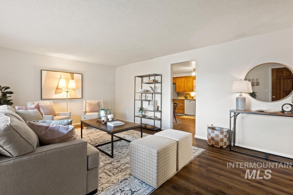 Living room with dark wood finished floors and a textured ceiling