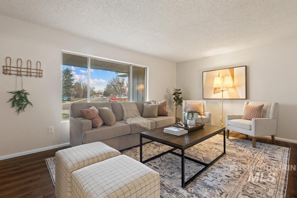 Living area featuring a textured ceiling and wood finished floors