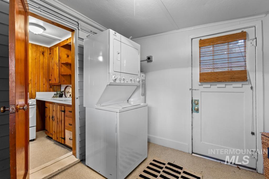 Laundry area featuring stacked washer and clothes dryer