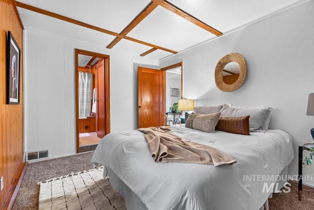 Carpeted bedroom with ensuite bathroom