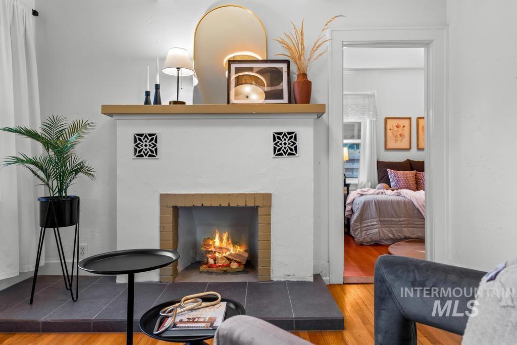 Living area featuring hardwood / wood-style flooring and a brick fireplace