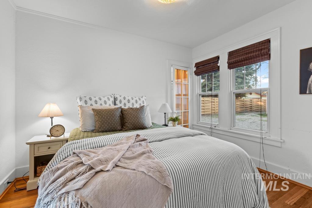 Bedroom featuring baseboards and wood finished floors