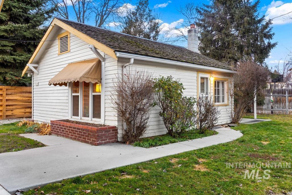 View of side of home featuring a chimney