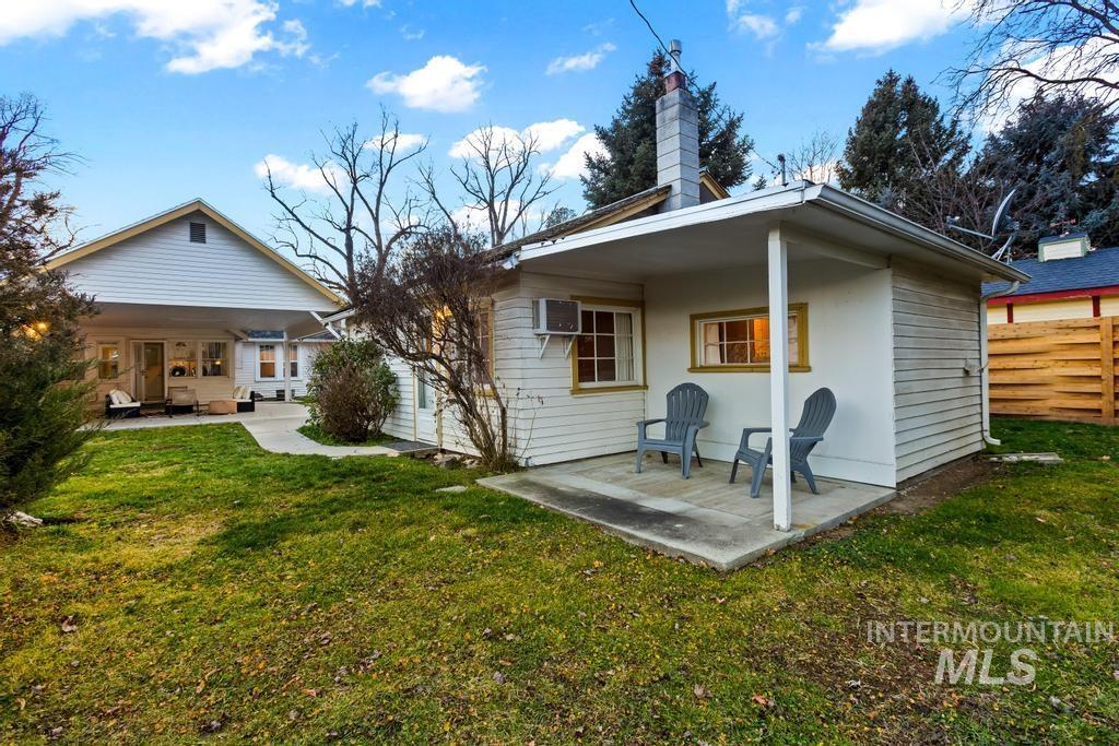Rear view of property with a patio, a chimney, and a wall unit AC