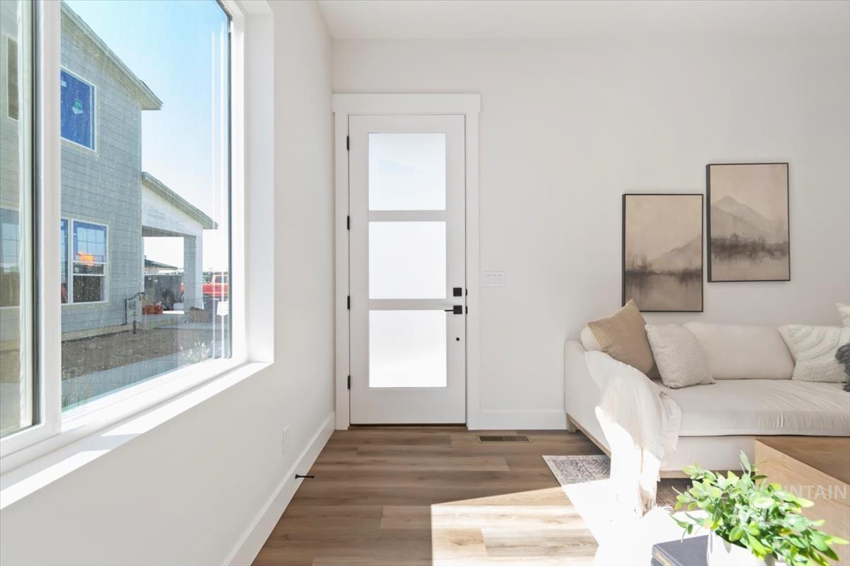Living area with wood finished floors and baseboards