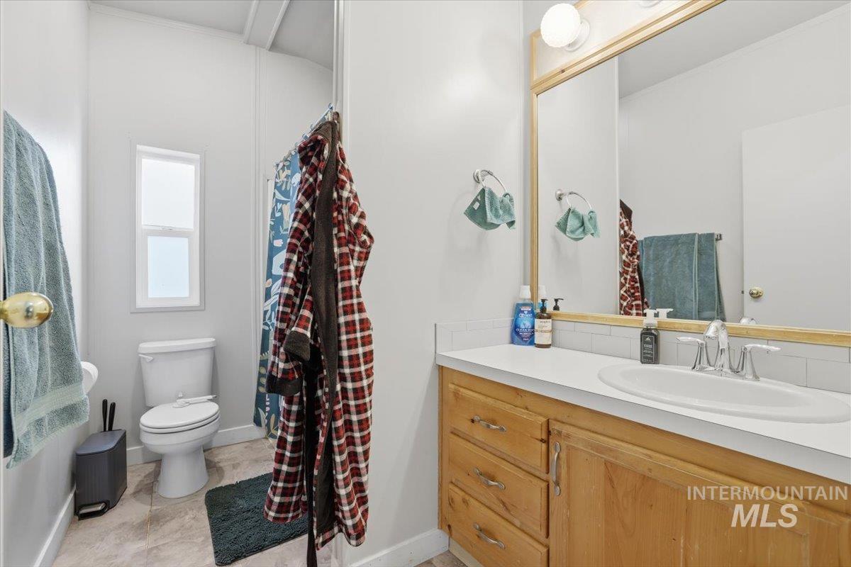 Bathroom featuring vanity and curtained shower
