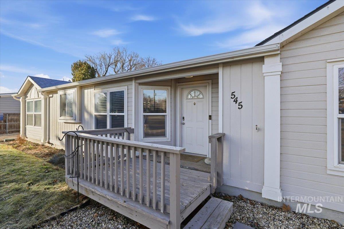 Entrance to property featuring a wooden deck