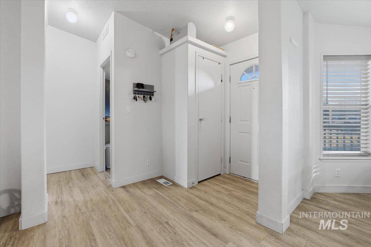 Hall featuring light wood-style flooring