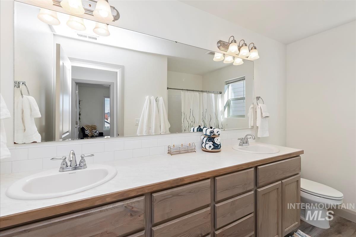Bathroom with double vanity and a shower with curtain