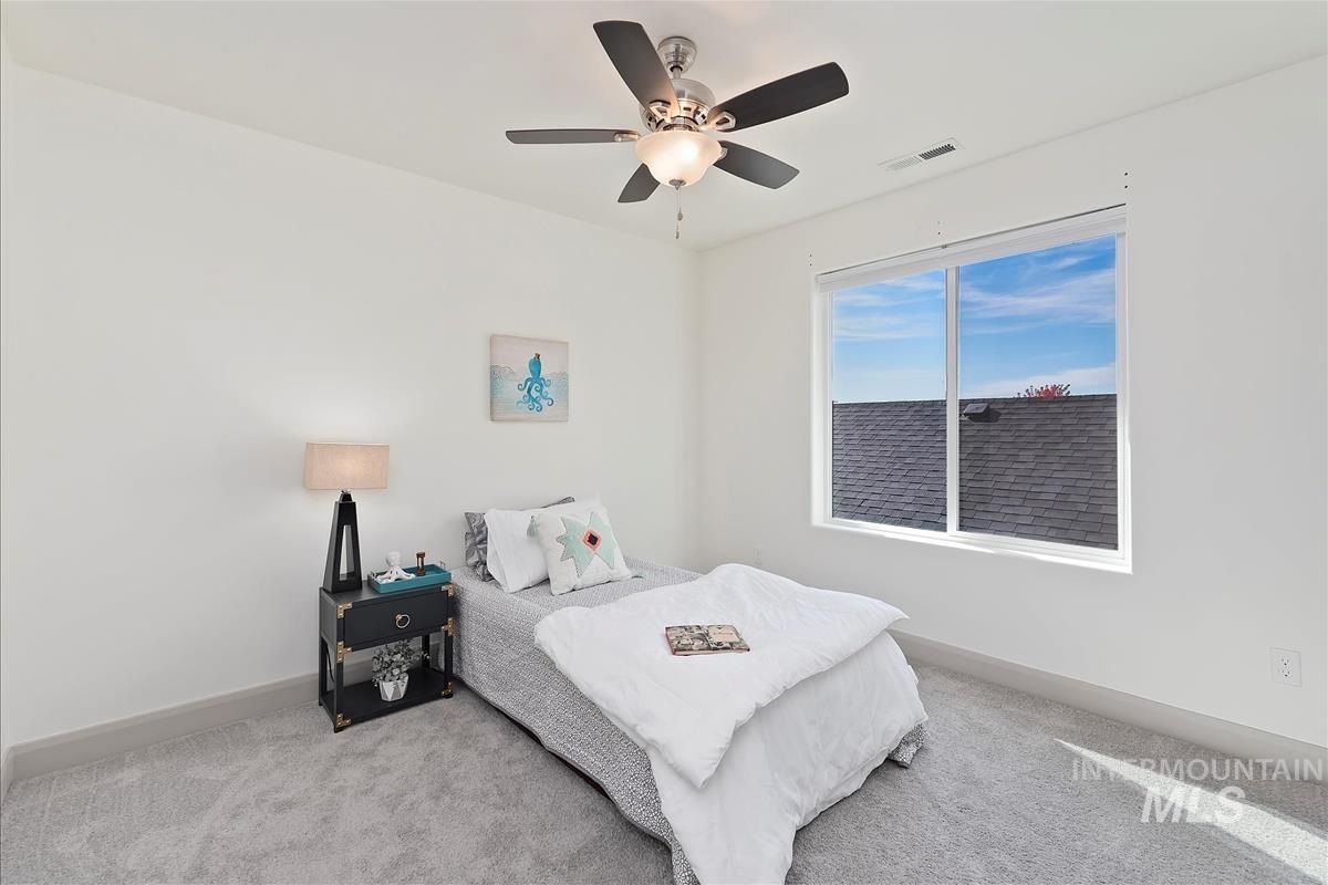 Bedroom with carpet and a ceiling fan