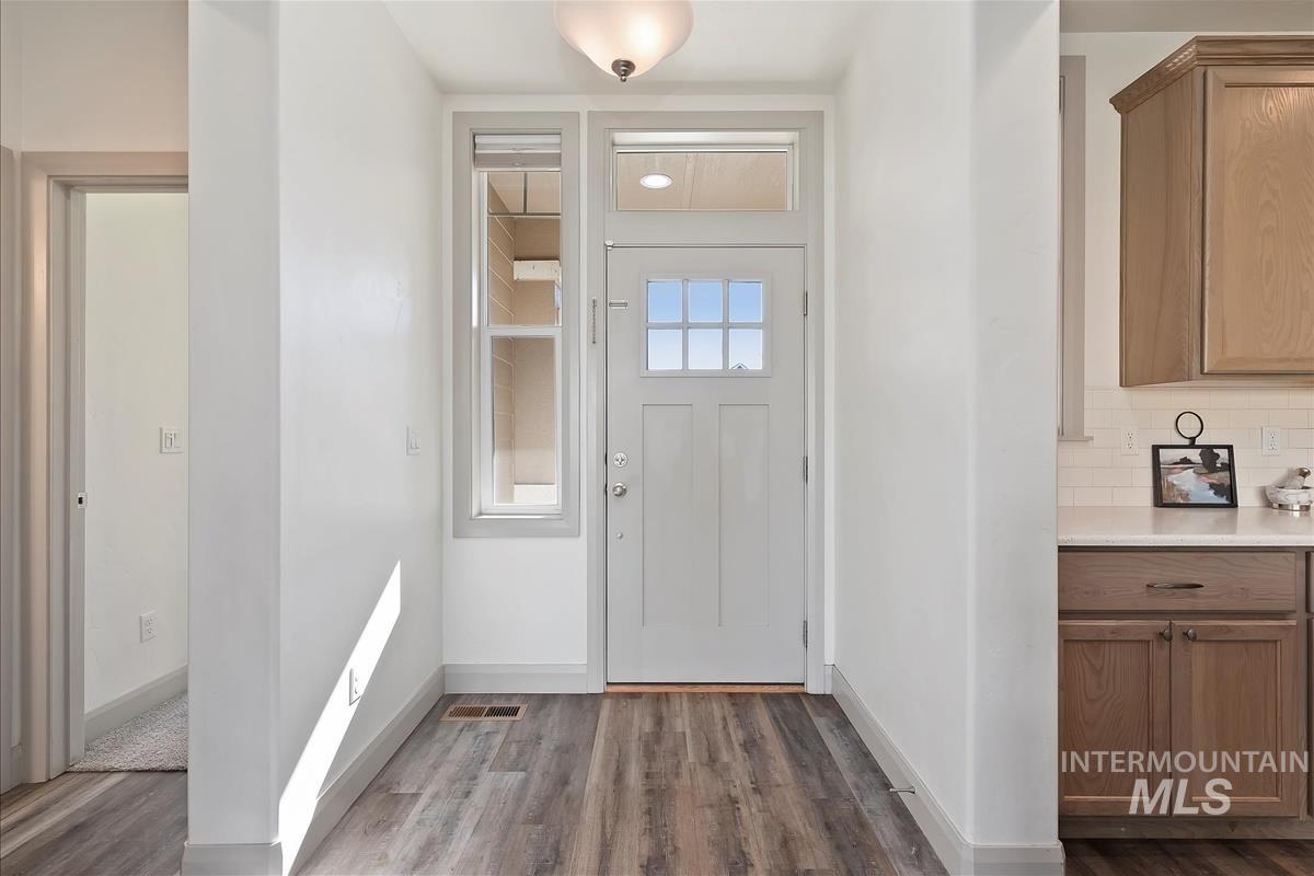 Foyer entrance with dark wood-style floors