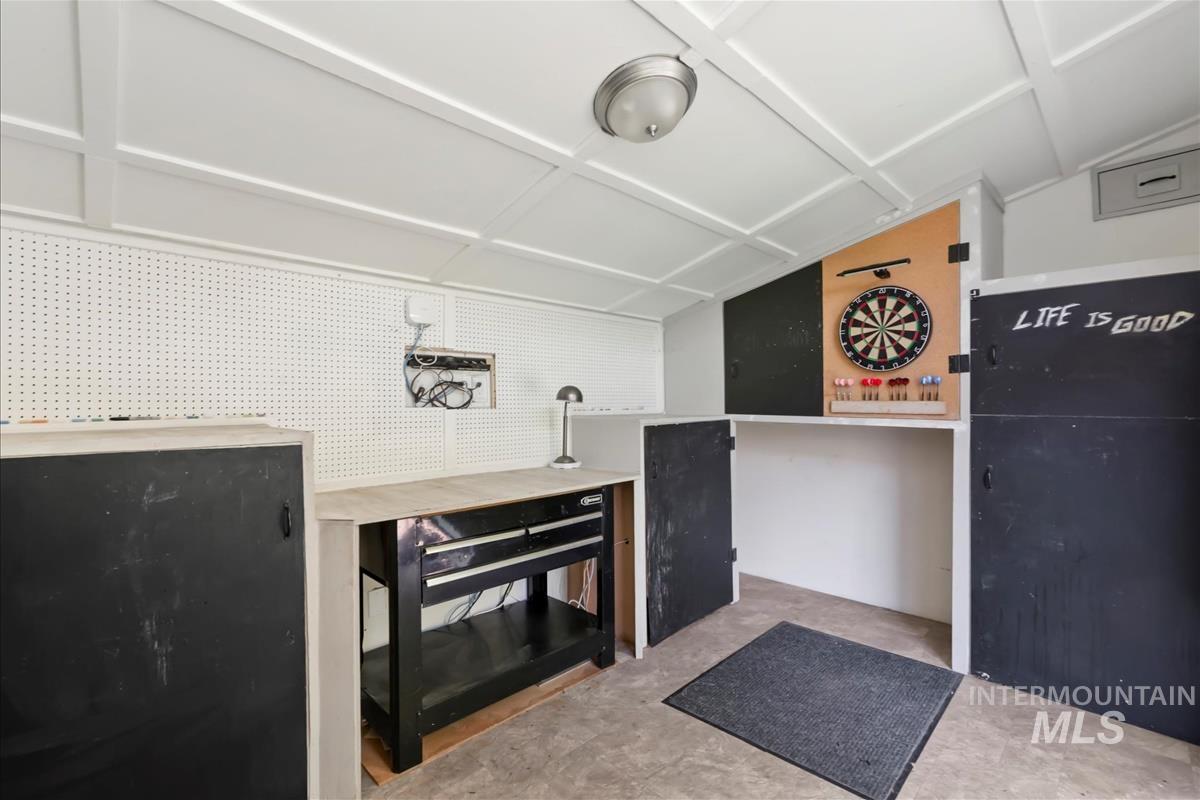 Storage Shed in backyard, drywalled and insulated with shelving and desk space use for any of your projects.