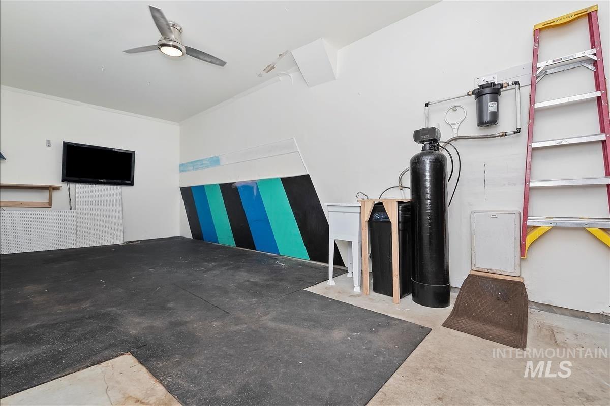 Garage with water softener and utility sink.