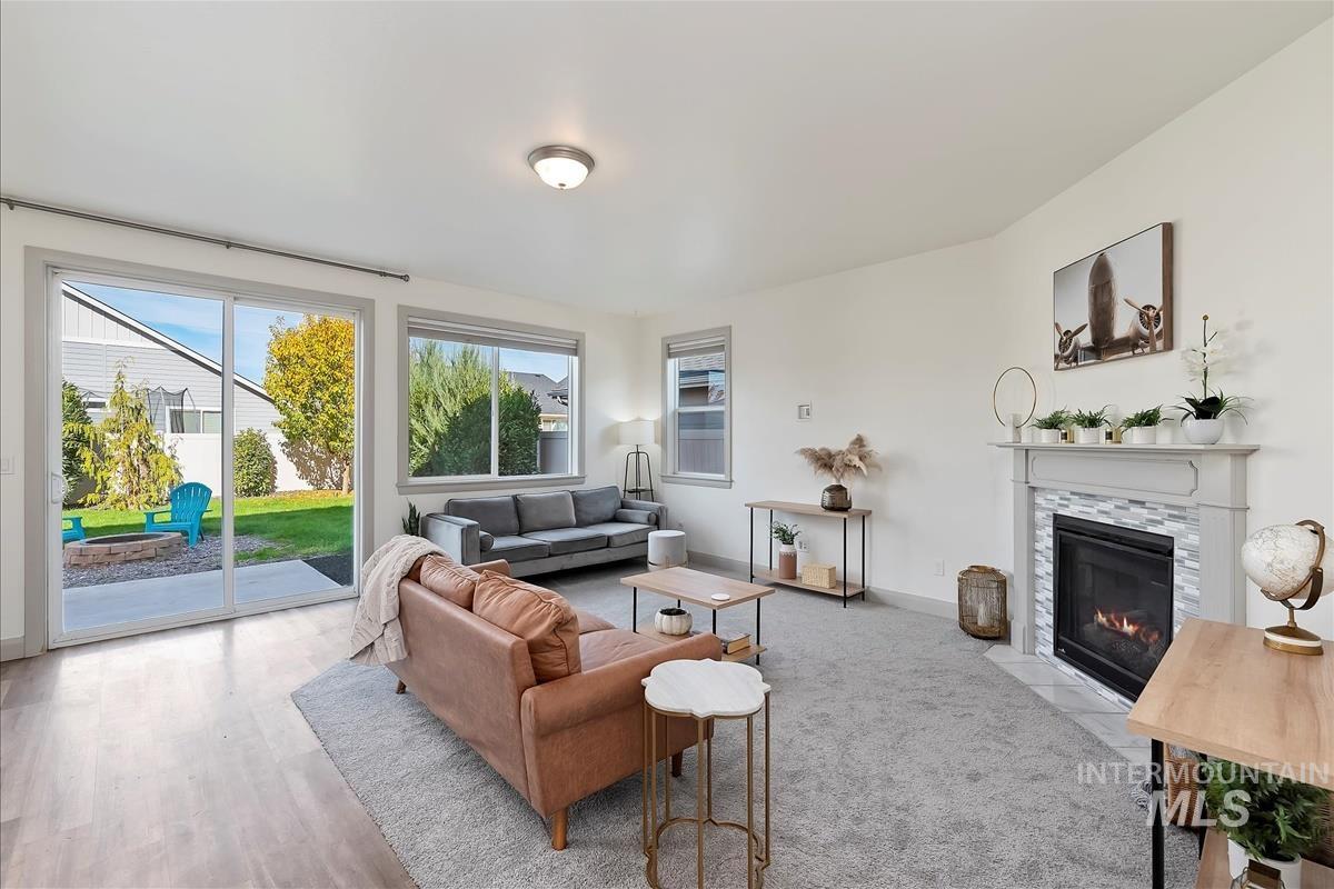 Living area with a tiled fireplace and baseboards