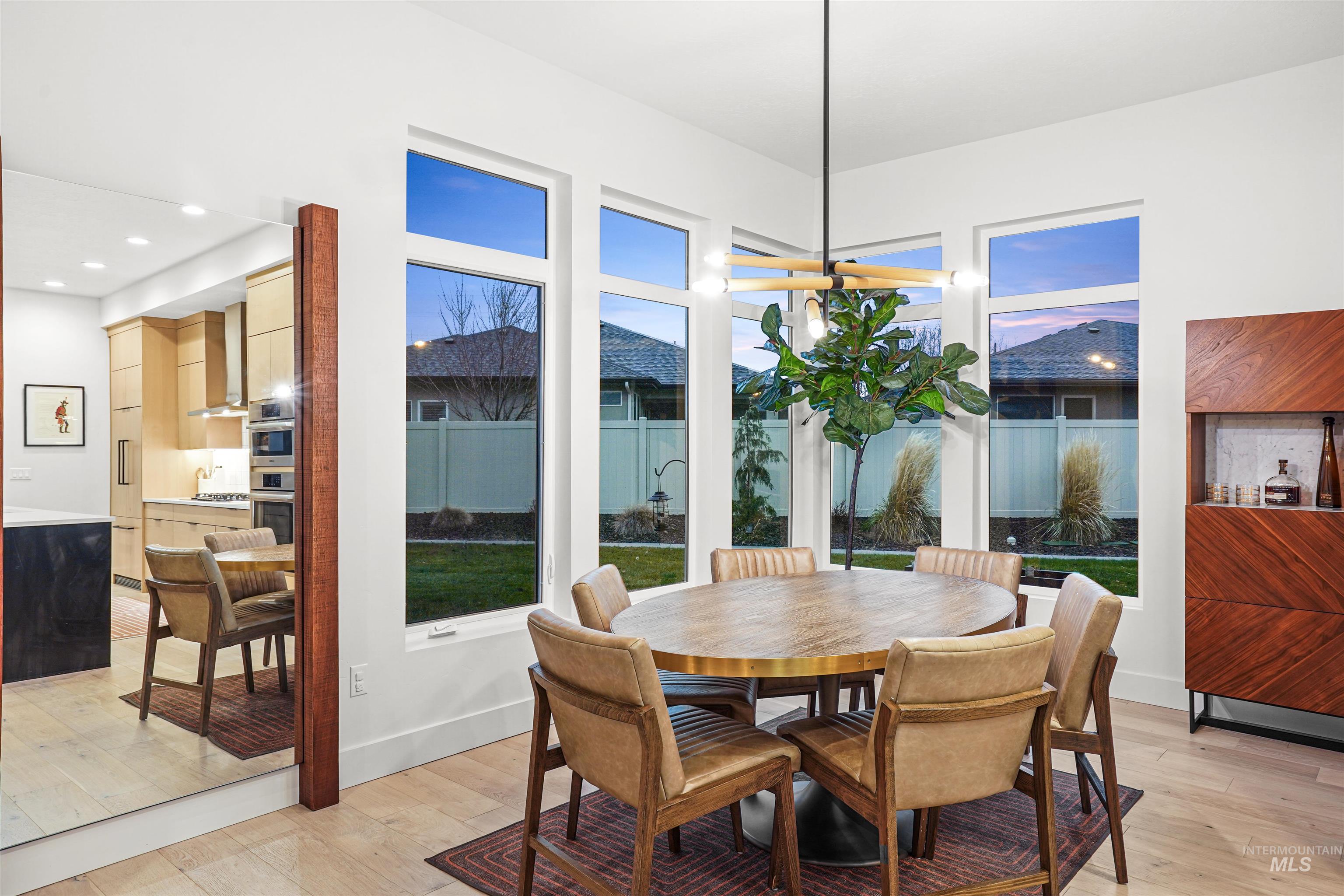 Dining room with light wood-style flooring and recessed lighting