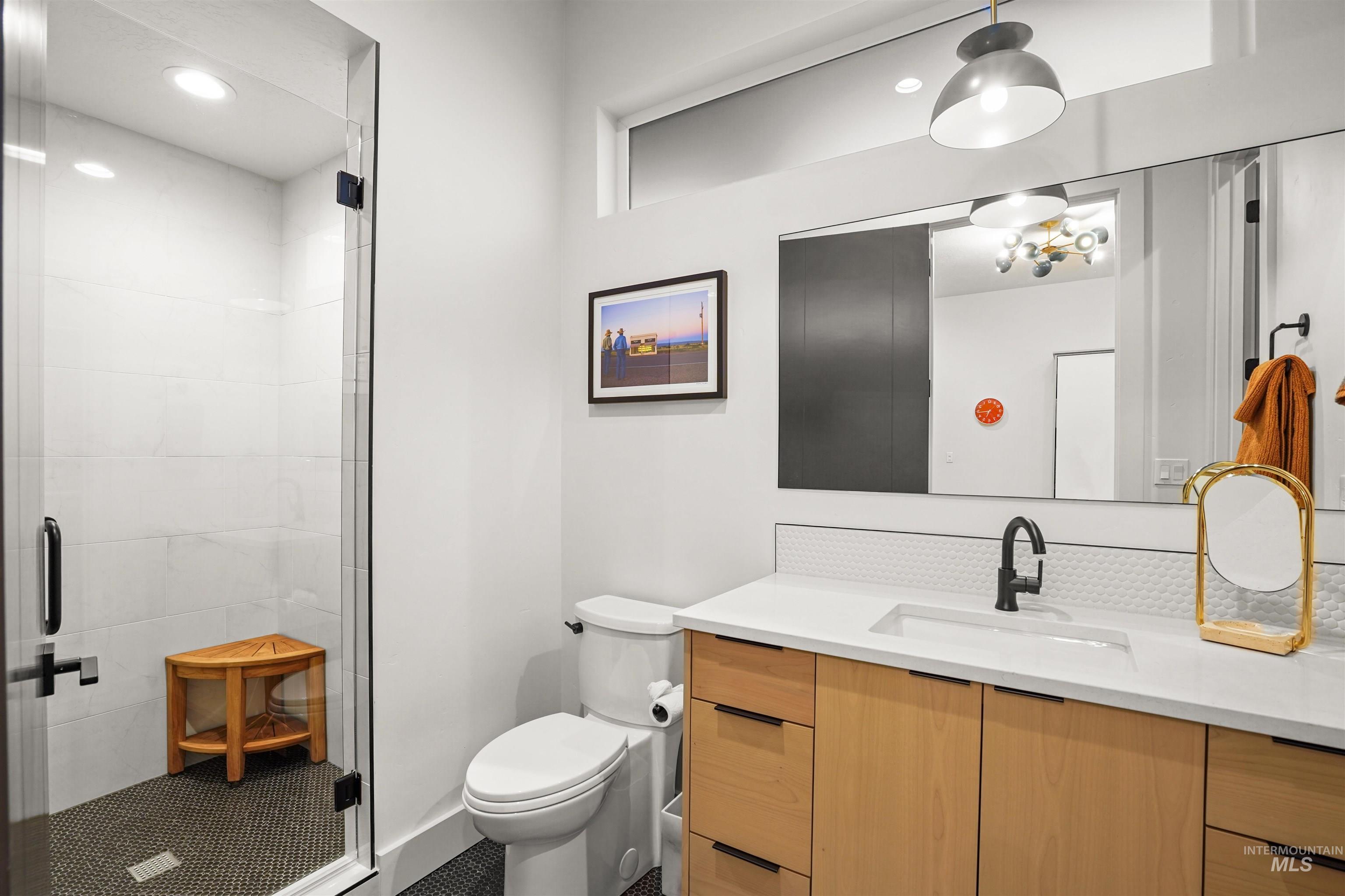 Bathroom featuring vanity, a shower stall, and recessed lighting