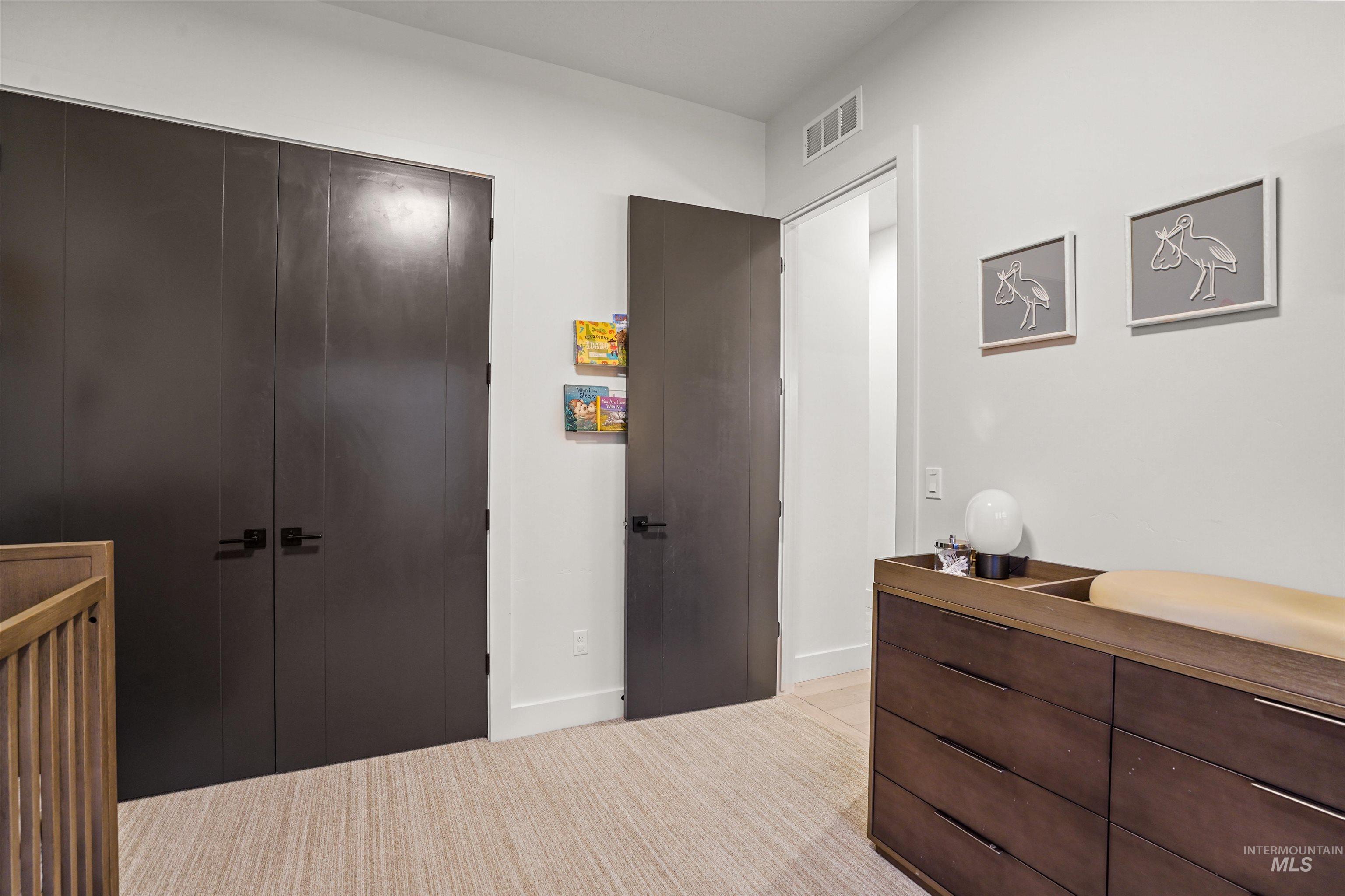 Bedroom with a closet and light carpet