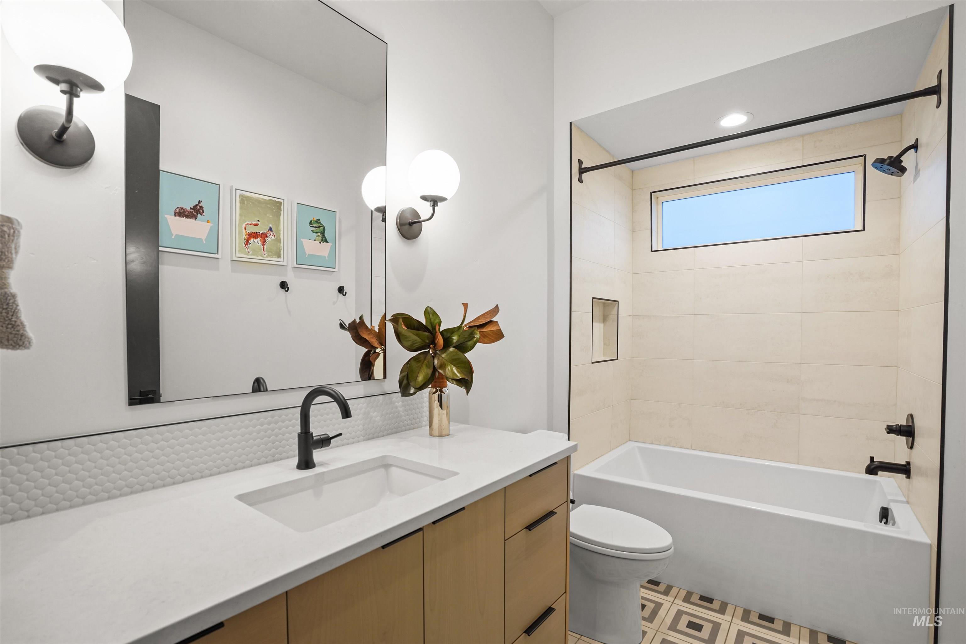 Full bathroom with vanity, shower / bath combination, backsplash, and recessed lighting