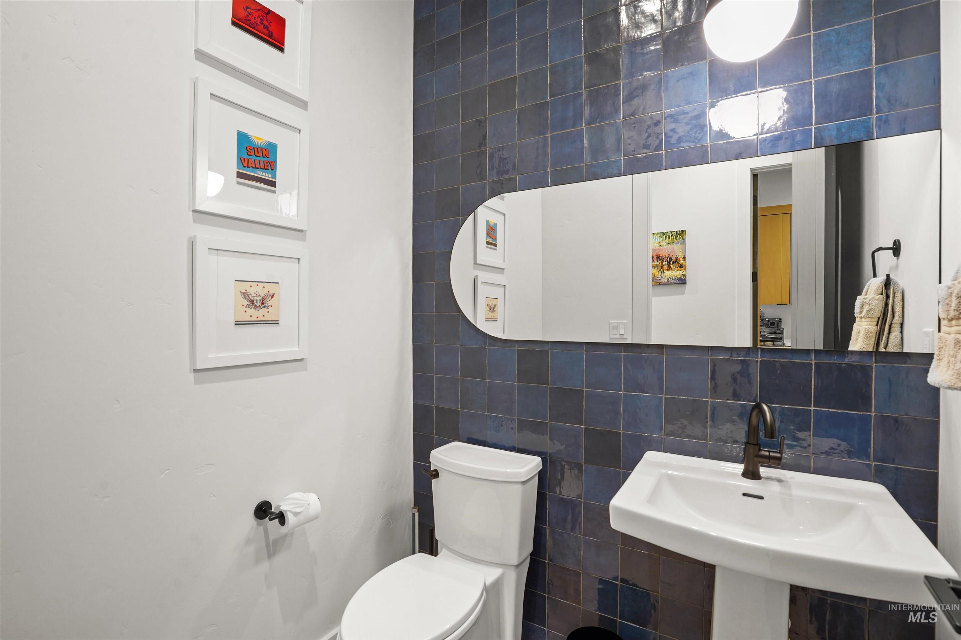 Bathroom with tile walls and decorative backsplash