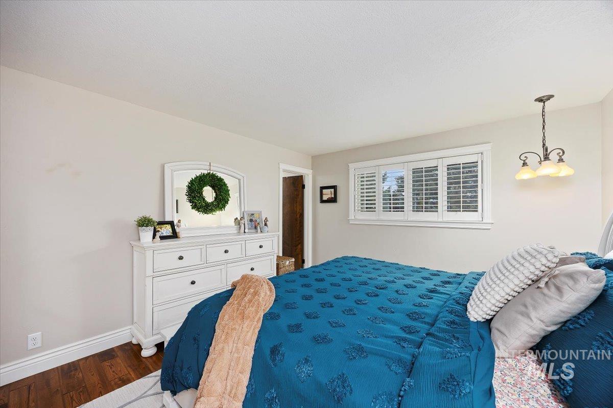 Bedroom with baseboards and wood finished floors